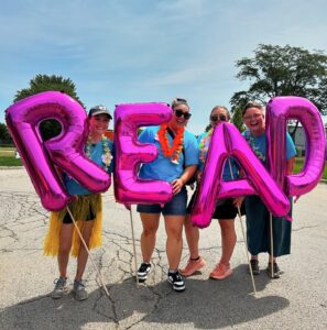 staff holding pink letters spelling read